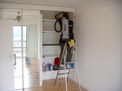 Reinigung mit Staubsauger auf der Leiter